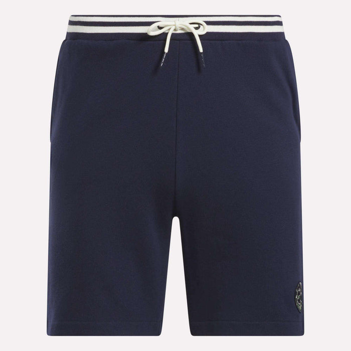 Reebok Men's Lawn Club Shorts in navy blue feature a white drawstring, striped elastic waistband, side pockets, and a small logo patch on the left hem. These sporty cotton shorts offer both comfort and style.