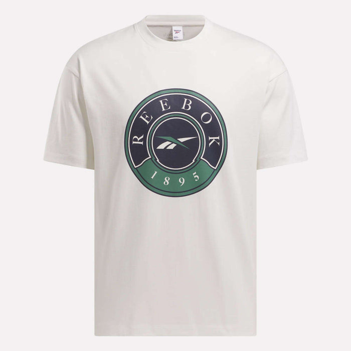 The Men's Lawn Club T-Shirt by Reebok is a white tee with a large circular Lawn Club logo on the chest, displaying "REEBOK," the brand emblem, and "1895" in black and green.