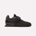 The Reebok Men's Legacy Lifter IV Shoes feature a black textured mesh upper, thick sole, and wide midfoot strap for added stability, displayed in side profile against a plain white background.
