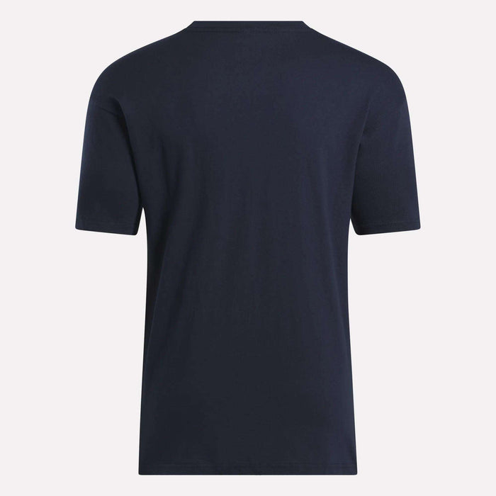 The Reebok Men's Stacked Vector T-Shirt, made from soft cotton in plain navy blue, is displayed from the back against a light background.