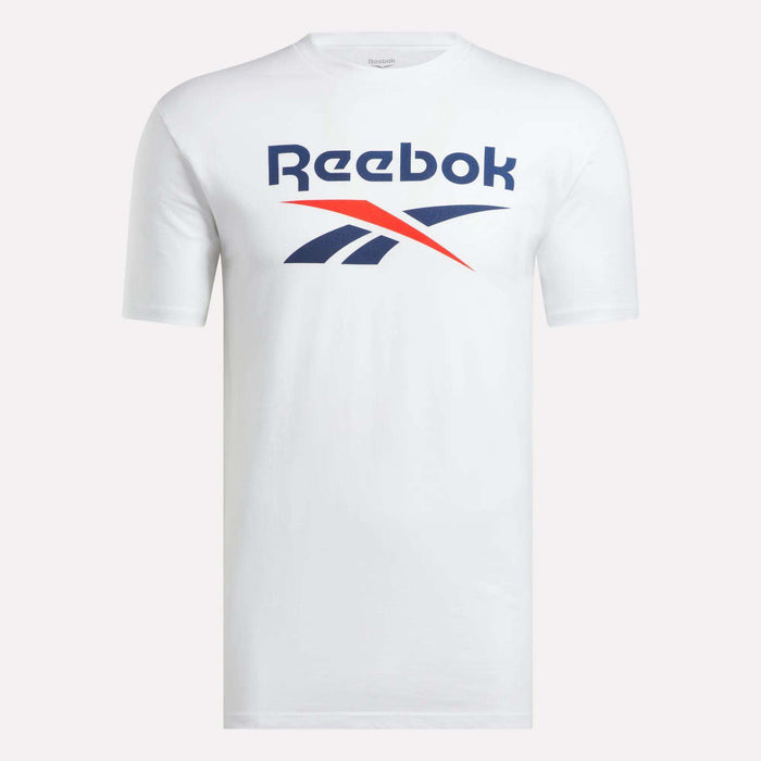 The Men’s Stacked Vector T-Shirt by Reebok is a classic white cotton tee with short sleeves, featuring the blue and red Reebok logo and brand name on the chest, shown against a plain light background.