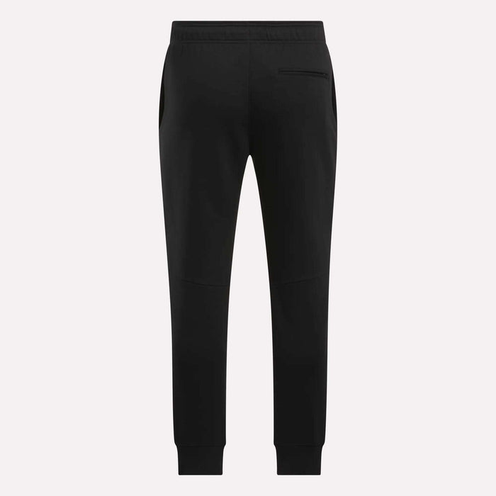 The Reebok Men's Motion Joggers in black slim fit are shown from the back, featuring an elastic waistband, side pockets, a single right back pocket, and tapered legs with ankle cuffs.