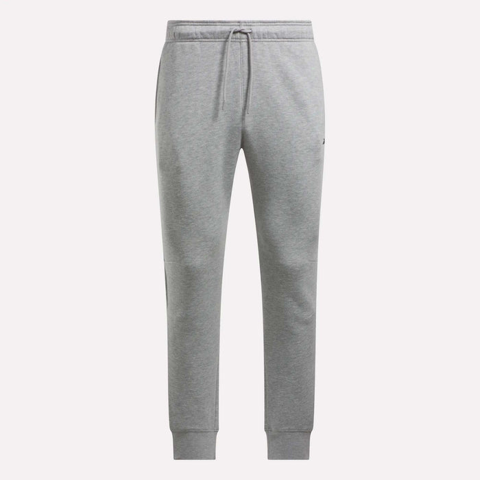 Reebok Men's Motion Joggers in light grey feature a slim fit, elastic waistband with front drawstring, side pockets, and ribbed cuffs, shown on a plain white background.
