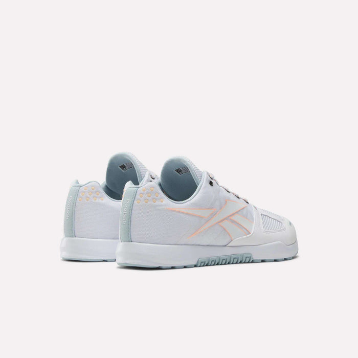 The Reebok Men's Nano 2.0 Training Shoes in white with light blue soles and accents, plus a pale orange logo outline on the side, ideal for functional fitness, are shown against a plain white background.