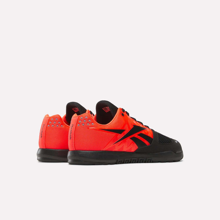 The Reebok Men's Nano 2.0 Training Shoes feature bright orange uppers, black soles, black laces, and bold black logos—perfect for functional fitness—displayed against a plain white background.