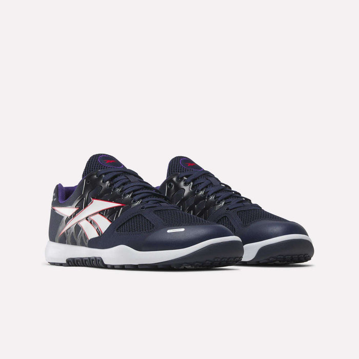 A pair of Reebok Men’s Nano 2.0 Training Shoes in navy blue with white soles, showcasing bold white and red Reebok logos on the sides and purple accents on the tongue, displayed against a plain white background—an ideal choice for functional fitness enthusiasts.