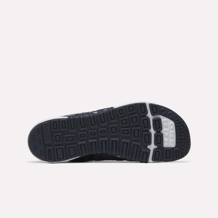 The image displays the black and white rubber outsole of the Reebok Men’s Nano 2.0 Training Shoes, featuring a textured, multi-square tread pattern engineered to provide superior grip and traction for functional fitness activities—all set against a plain white background.