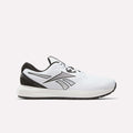 A white, black, and silver Reebok men's Nanoflex 2 Training Shoe is shown from the side against a plain background. The athletic sneaker features black accents, trim on the sole, and a black heel with the Reebok logo displayed on the side. Designed for training, it incorporates breathable mesh for enhanced comfort.
