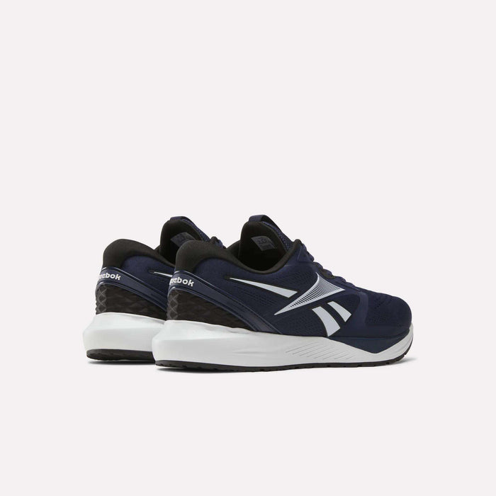 A pair of Reebok Men's Nanoflex Trainer 2 shoes in navy blue with white soles and logos, displayed from the back and side on a plain light background.