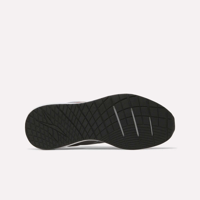 The image displays the black rubber outsole of the Men's Nanoflex 2 Training Shoes by Reebok, featuring a geometric traction pattern and three deep horizontal grooves for enhanced flexibility. The background is plain white.