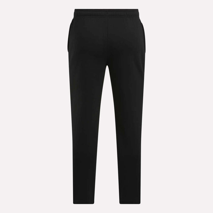 Men's Patent Pants by Reebok in black, featuring a slim fit, elastic waistband, and tapered legs, shown from the back against a plain light background.