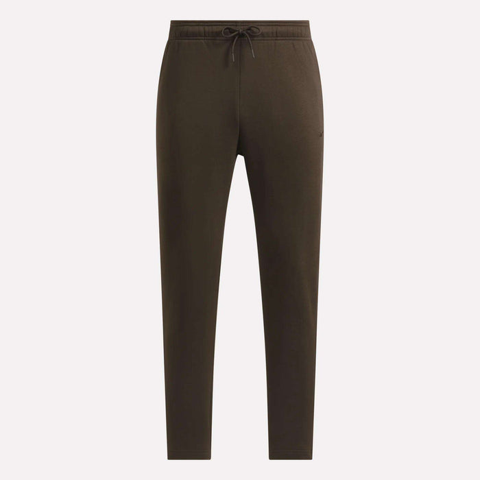 Men’s Patent Pants by Reebok in dark olive green, featuring an adjustable waistband with a drawstring and slim-fit tapered legs, showcased against a plain light background.
