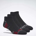 Three pairs of Reebok Men's Performance Nylon Low Cut Socks are displayed on a white background, featuring athletic style and moisture-wicking comfort for active performance.