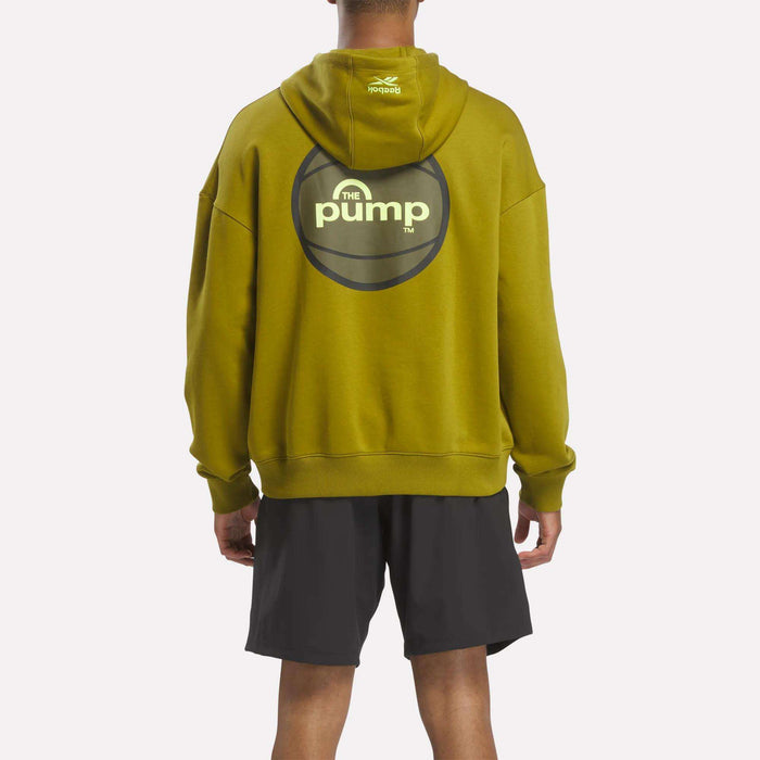A person is shown from behind against a plain background, wearing the Reebok Men's Pump OG Hoodie in green, featuring the pump logo on the back, paired with black shorts.