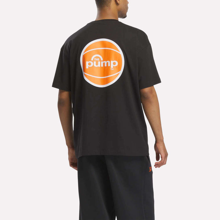 A person is seen from behind wearing the Reebok Men's Pump OG T-Shirt, a black men's tee featuring an orange and white Reebok Pump logo on the back for a retro basketball-inspired look.