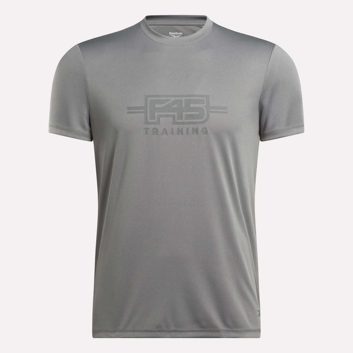 The Men’s Reebok x F45 Training T-Shirt by Reebok is a gray, short-sleeve men’s tee featuring “F45 Training” printed on the front in coordinating gray lettering, made with signature Reebok performance quality, and shown against a plain white background.
