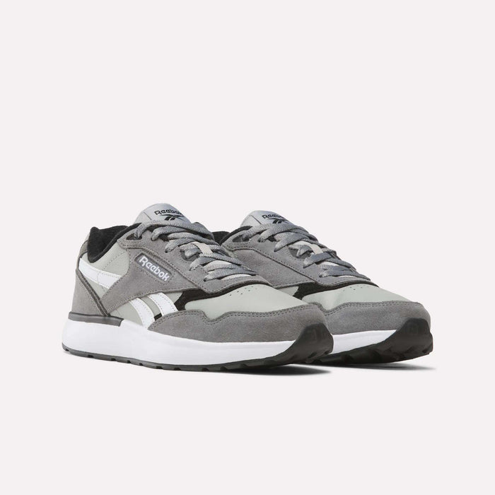 A pair of Men’s Run LXS Shoes by Reebok in gray and white, crafted from full-grain leather with white soles and black outsoles, positioned side by side on a plain white background.