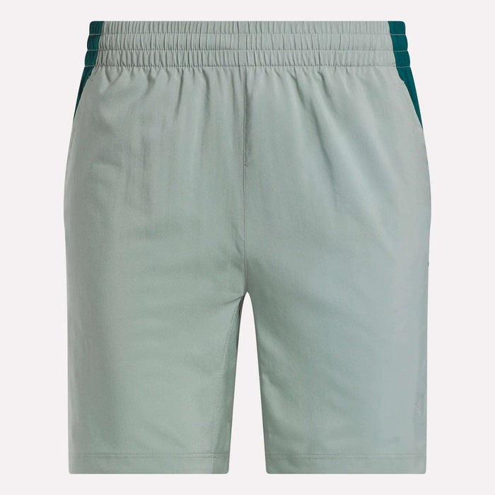Reebok Men's Run Shorts in light green with inner tights, dark green side panels, elastic waistband, and two side pockets. These running shorts feature a simple front design for a sleek look.