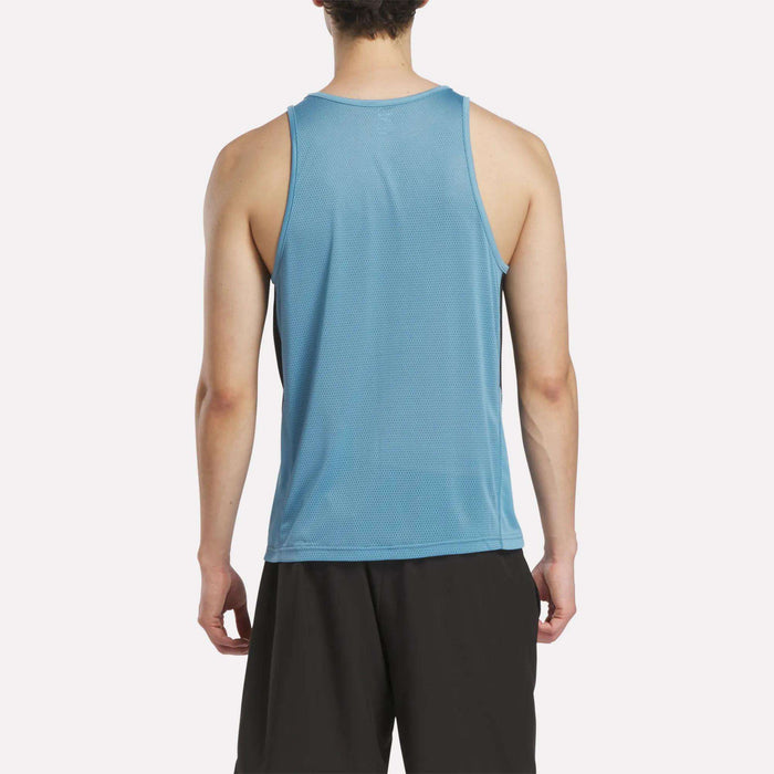 A person is seen from behind wearing a light blue Reebok Men's Run Speedwick Singlet and black shorts, standing against a plain white background.