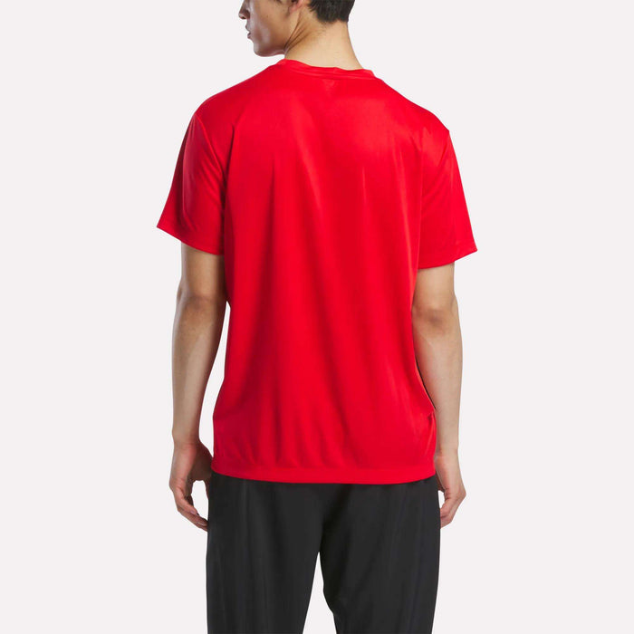 A man is shown from the back wearing a Men's Short Sleeve Tech Training T-Shirt by Reebok in red and black pants, standing against a plain white background.