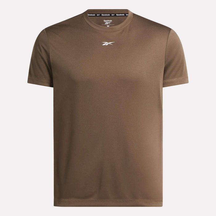The Men's Short Sleeve Tech Training T-Shirt by Reebok features RBK-DRY fabric, short sleeves, a small white logo on the chest, and branded tape inside the neckline. Shown in brown against a light background, it's ideal for gym workouts.