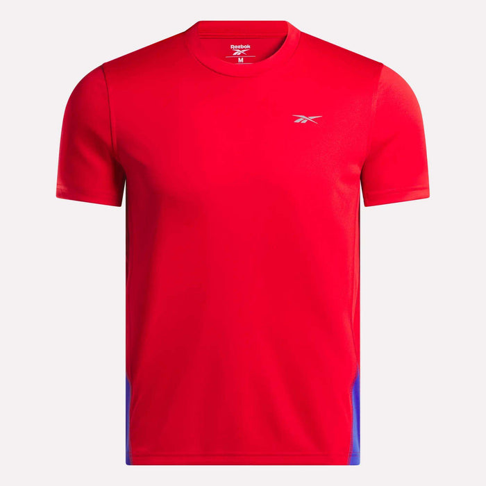 The Men's Short Sleeve Vector T-Shirt by Reebok is bright red with RBK-DRY tech, subtle blue side accents, and a small white logo on the left chest, shown against a plain white background.