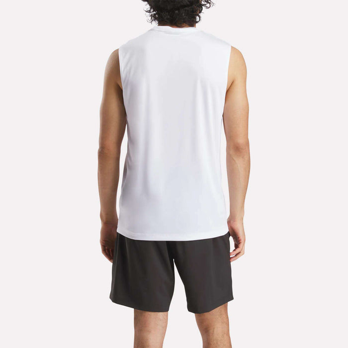 A person stands with their back to the camera, wearing a Reebok Men's Sleeveless Tech Training T-Shirt and black shorts against a plain, light-colored background.