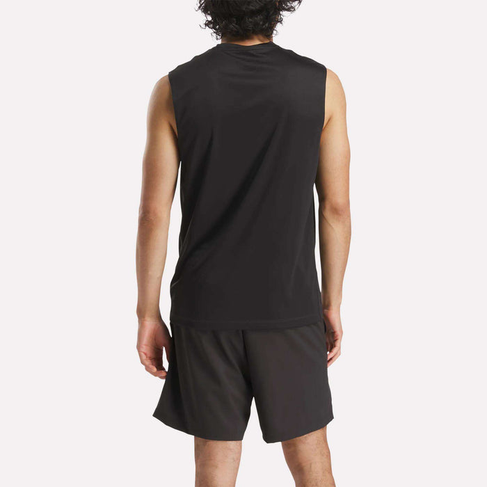 A person with curly hair is seen from the back, wearing a Reebok Men's Train Sleeveless Tech Tee and black lightweight polyester shorts, standing against a plain light background.