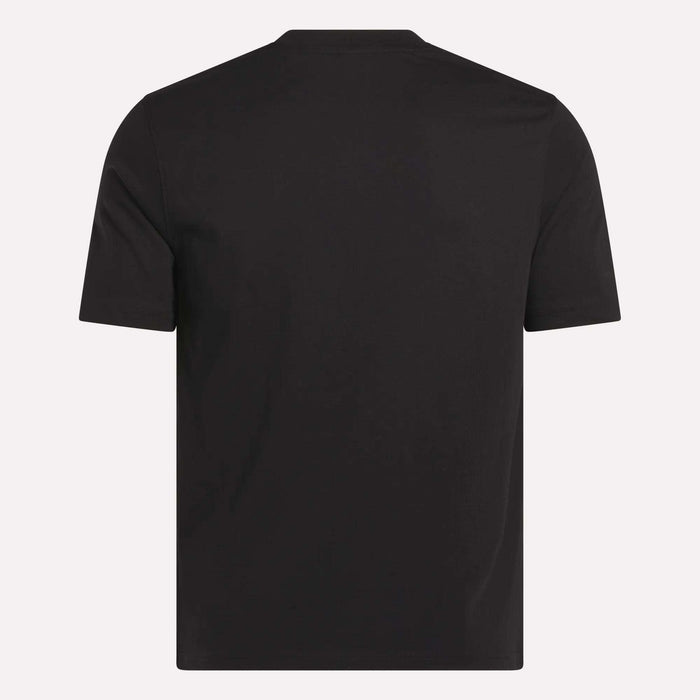 The Reebok Men's Small Logo Crewneck Short Sleeve T-Shirt is shown from the back in soft black cotton jersey. It features a simple crew neckline and minimal visible logos or designs, set against a light background.