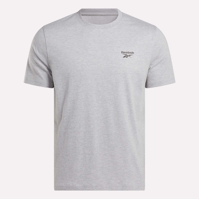 The Reebok Men's Small Logo Crewneck Short Sleeve T-Shirt features a classic fit in light grey, made from soft cotton jersey with short sleeves, a crew neckline, and a small black Reebok logo on the left chest.
