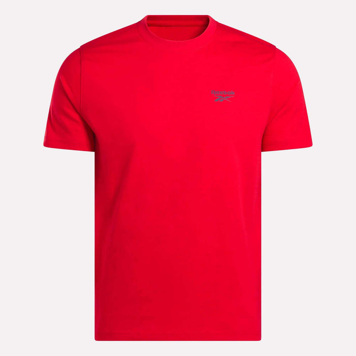 The Reebok Men's Small Logo Crewneck Short Sleeve T-Shirt is a bright red cotton jersey tee with a crew neckline and a small gray logo on the left chest, shown on a plain white background.