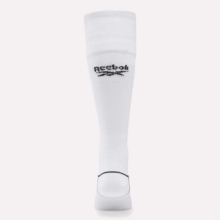 A single Men’s Soccer Crew Sock by Reebok is displayed upright. The white sock features the black Reebok logo and vector near the top, has a ribbed cuff, moisture-wicking fabric, and a black line above the toe area.