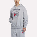 A man stands against a plain white background wearing the Reebok Men’s Starcrest Relaxed Hoodie and matching light grey marl sweatpants, both featuring a bold red and black Starcrest logo. Made from soft fleece, this classic hoodie offers ultimate comfort.