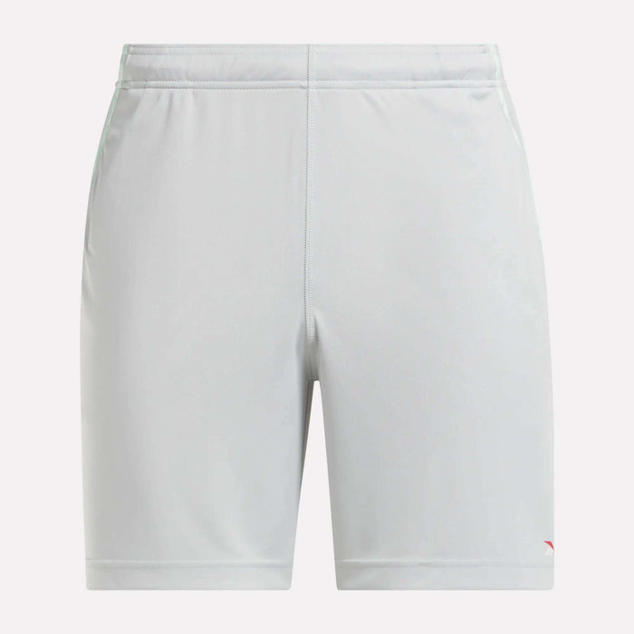 Front view of plain light gray Reebok Men's Train Blocked Knit Shorts featuring an elastic waistband and a small red logo on the lower left leg, ideal for workout enthusiasts.