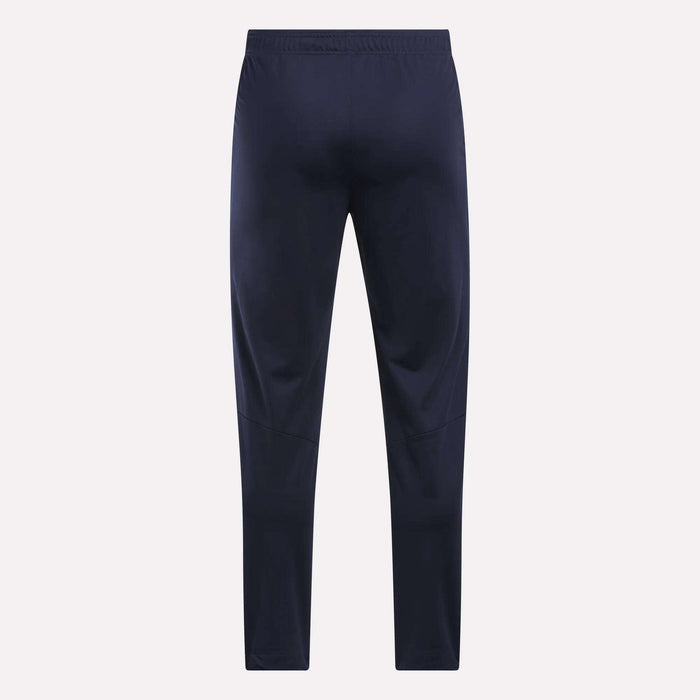 Men's Train Knit Pants by Reebok in navy blue, featuring an elastic waistband, displayed flat and facing forward against a plain light background.