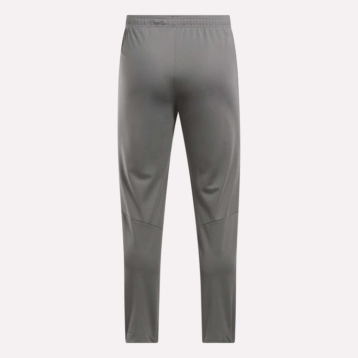 Back view of Reebok Men's Train Knit Pants in gray, featuring an elastic waistband and subtle leg seam details, shown against a plain light background.