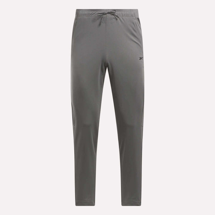 Men's Train Knit Pants by Reebok, gray with a drawstring waistband, tapered legs, and a small logo on the left thigh, shown against a plain white background.