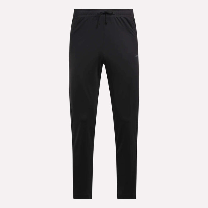Reebok Men's Train Knit Pants shown in black with a slim fit, elastic waistband, and drawstring. These minimalistic pants are ideal for workouts or casual wear, displayed against a light plain background.