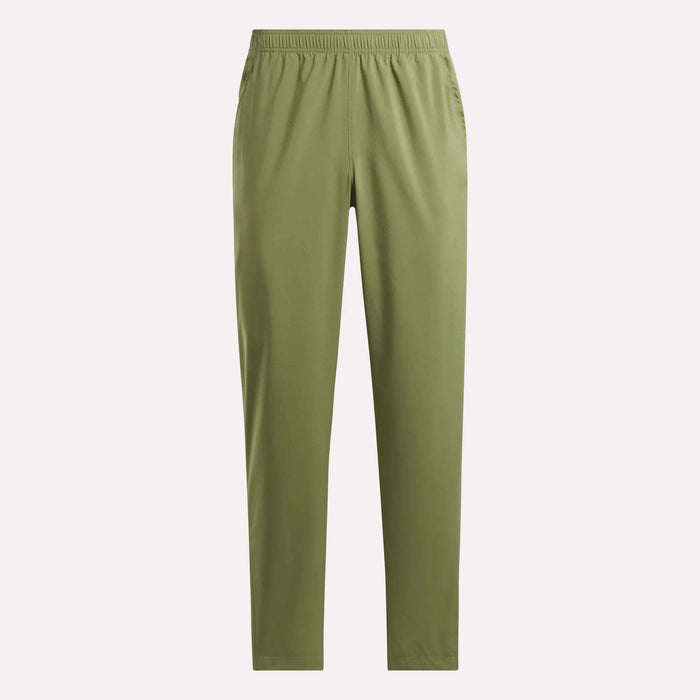 The Reebok Men's Train Woven Unlined Pants are olive green, straight-leg workout pants with an elastic waistband and side pockets, made from lightweight fabric and shown against a plain light background.