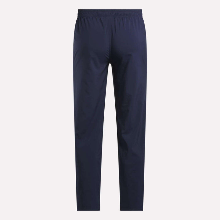 Reebok Men's Train Woven Unlined Pants in navy blue with an elastic waistband, shown from the back against a light background—ideal as lightweight workout or stylish gym pants.