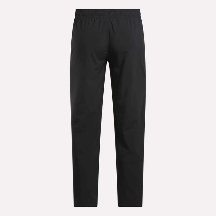 The Reebok Men's Train Woven Unlined Pants in black are lightweight workout pants, ideal for gym training, shown on a white background.