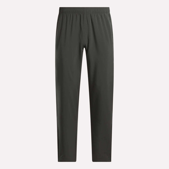 Reebok Men's Train Woven Unlined Pants in dark gray, featuring a straight-leg cut and elastic waistband. Lightweight and ideal for workouts, shown against a plain light background.