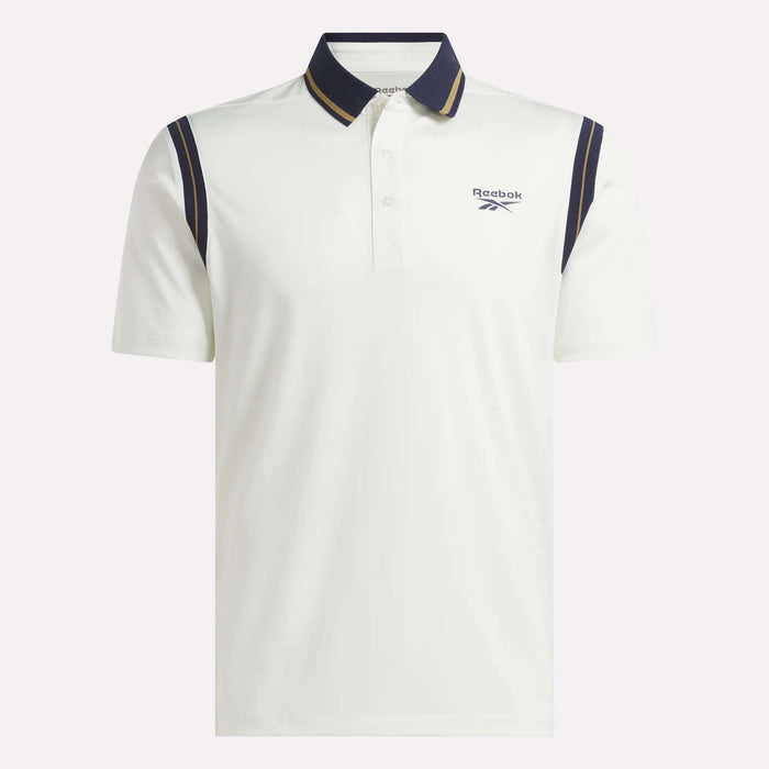 The Men's Varsity Polo Shirt by Reebok is a white golf polo crafted from breathable RBK-DRY fabric, featuring a black collar, gold trim, and navy shoulder stripes. It includes short sleeves, a button placket, and the Reebok logo on the left chest for a stylish finish.