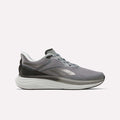 The Reebok Men's Viva Speed Shoes in Grey 4/Grey 5/Black feature a sleek athletic design with black and white accents, a cushioned white sole for enhanced comfort, and a convenient lace-up closure. These breathable men's running shoes are presented against a plain white background.