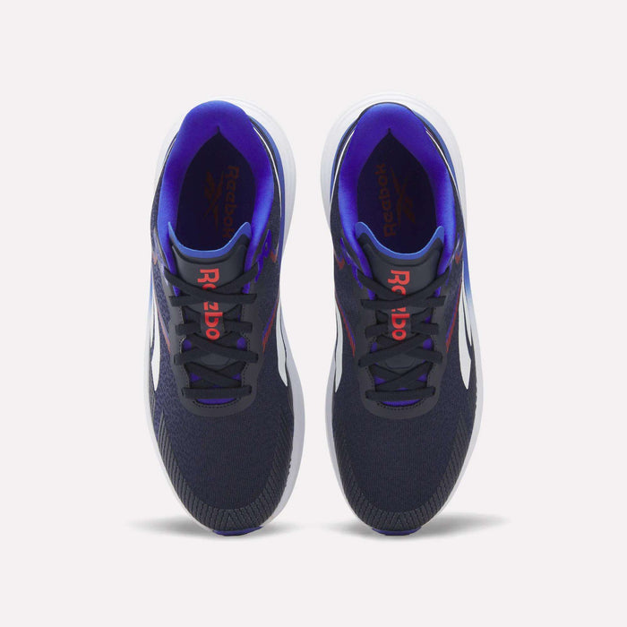 A pair of Reebok Men's Viva Speed Shoes in navy blue, featuring white soles, red Reebok logos on the tongues, and a purple inner lining, are displayed from a top view against a white background. Designed for both comfort and performance, these cushioned shoes are ideal for men seeking style and support.