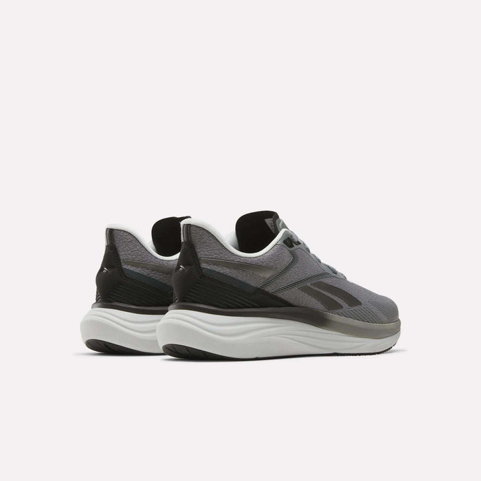 A pair of Reebok Men's Viva Speed Shoes in gray and black, featuring thick white soles, are shown from the back and slightly to the side against a plain white background. Designed with cushioning for comfort and style, these shoes are ideal for any athletic activity.
