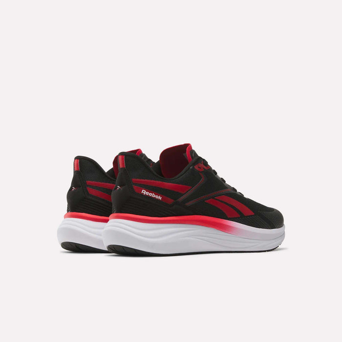 A pair of Reebok Men's Viva Speed Shoes in black with red accents and thick white soles are displayed to showcase both the side and back views against a plain white background. These cushioned sneakers combine comfort with a stylish design.