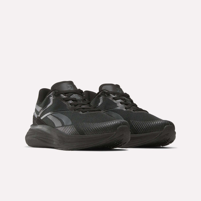 A pair of Men's Viva Speed Shoes by Reebok in black with dark gray accents, thick soles, textured uppers, and black laces are displayed side by side on a white background.