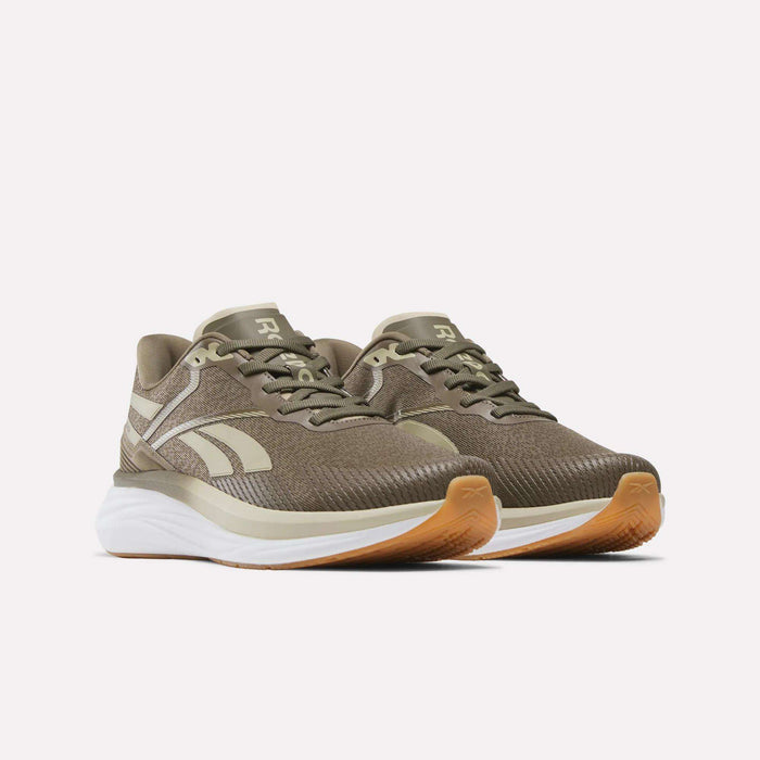 A pair of Reebok Men's Viva Speed Shoes in brown, featuring white soles, gum-colored outsoles, and a cushioned midsole for enhanced comfort, displayed on a light background.