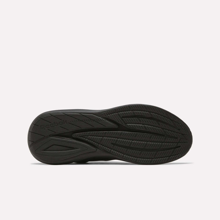 The image displays the black rubber outsole of Men's Viva Speed Shoes by Reebok, highlighting textured grooves and patterns for traction, set against a plain white background.